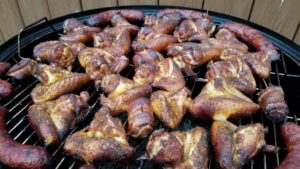 First batch of wings on the Weber Smokey Mountain Cooker along with some smoked jalapeño sausage!