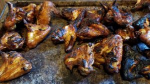 Wings after 15 minutes directly above the charcoal to crisp up the skin. Notice the 5 on the left that didn't get any BBQ sauce?